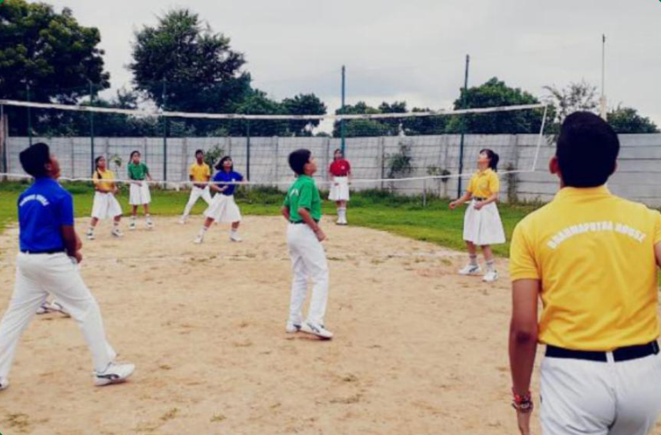 Students playing volleyball on an outdoor court